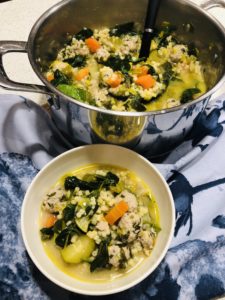 Showing a pot and bowl of the healthy meatball soup