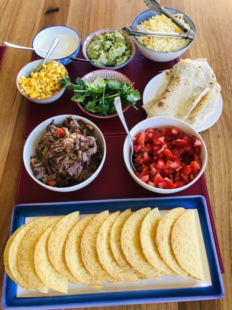 slow cooked beef tacos with all the trimmings