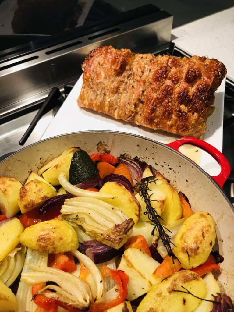 Roast pork served with roasted vegetables