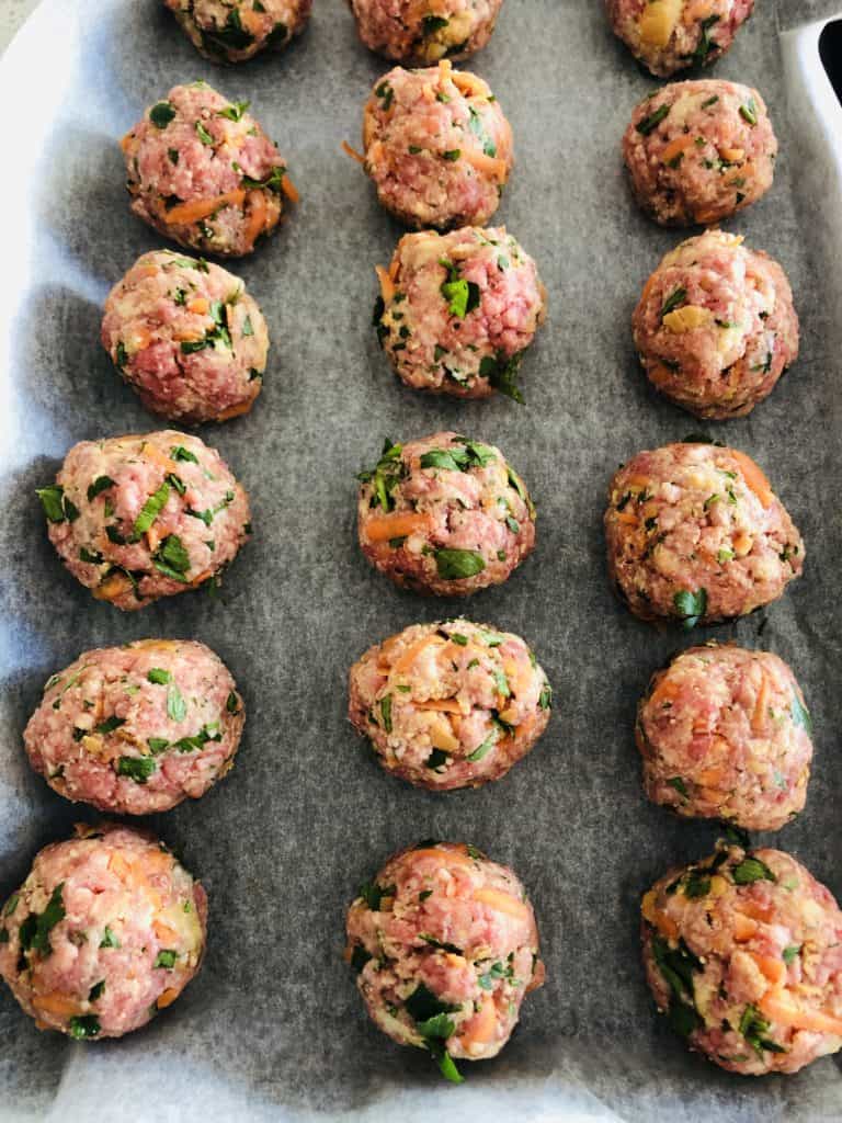 Rolled meatballs ready to be fried