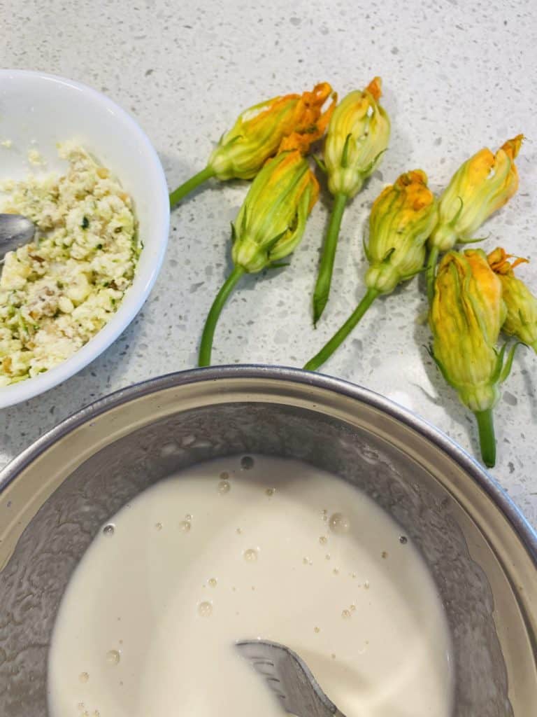 Making stuffed zucchini flowers