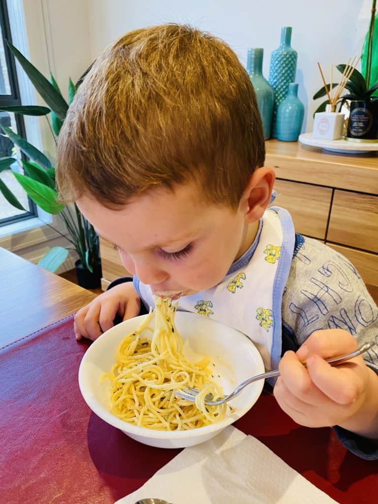 My three year old eating creamy salmon pasta 